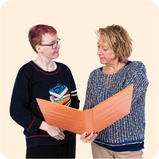 A person supporting someone to read a document.