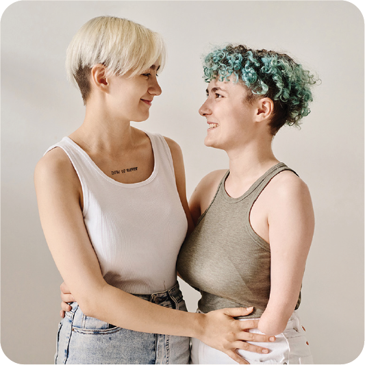 2 people with their arms around each other.